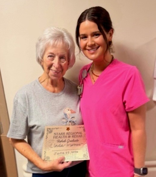 Patient poses with therapist after therapy